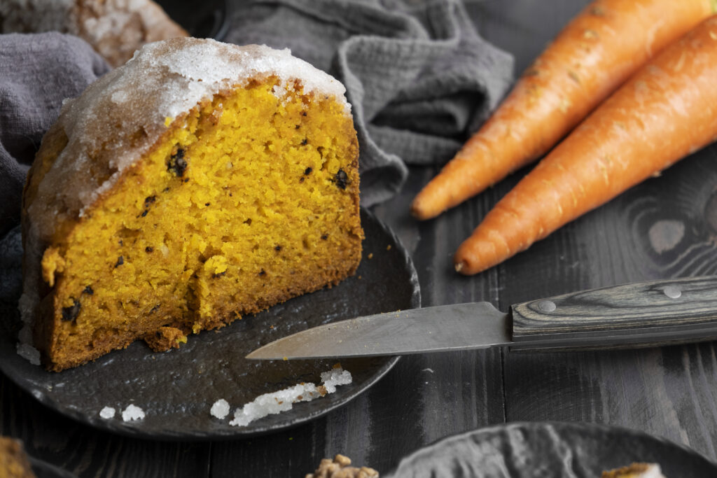 Freshly baked carrot cake on a cooling rack, highlighting its moist texture achieved with vegetable oil.